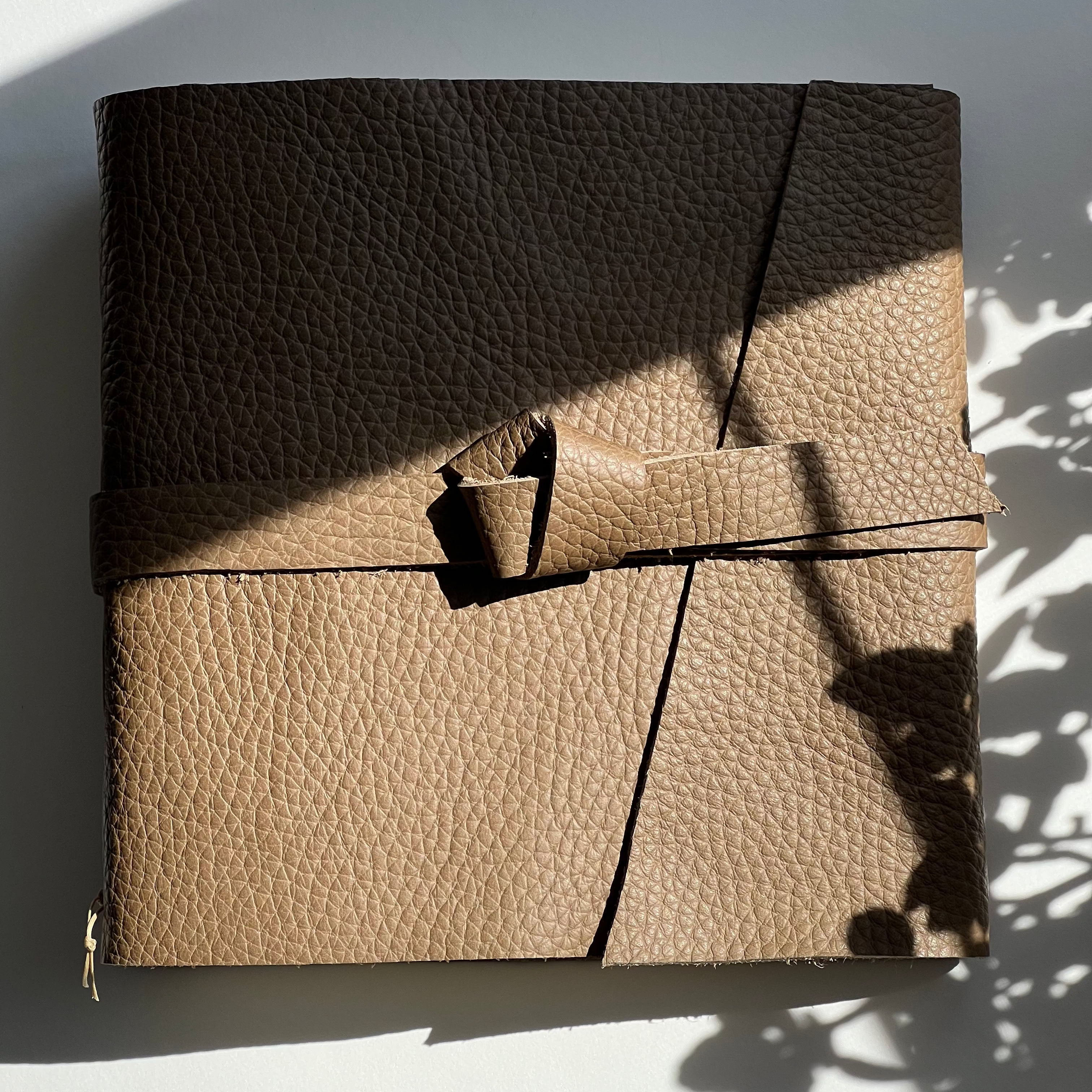 Handmade coffee latte leather photo album or wedding guest book featuring genuine leather.
