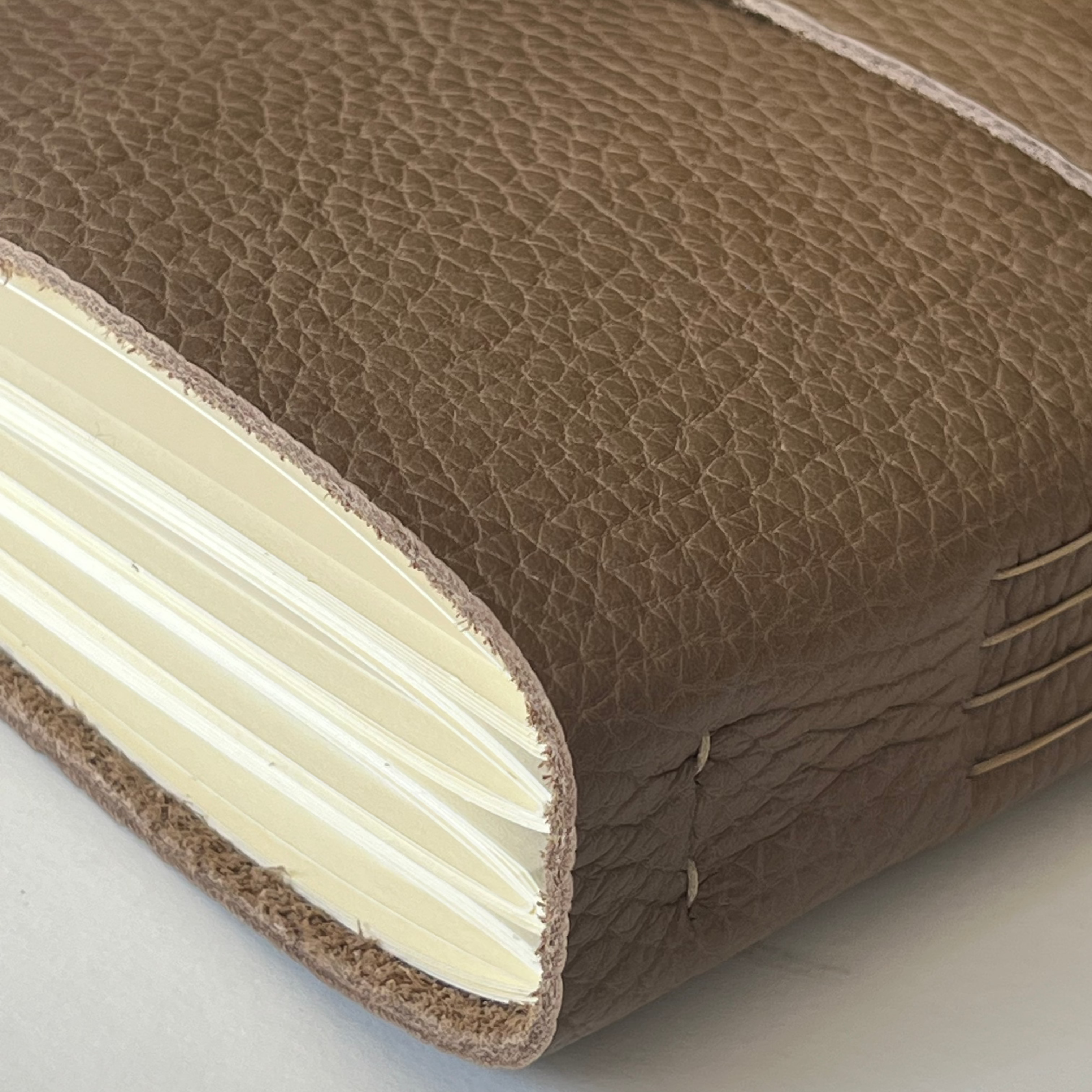 Handmade coffee latte leather photo album or wedding guest book featuring custom engraving