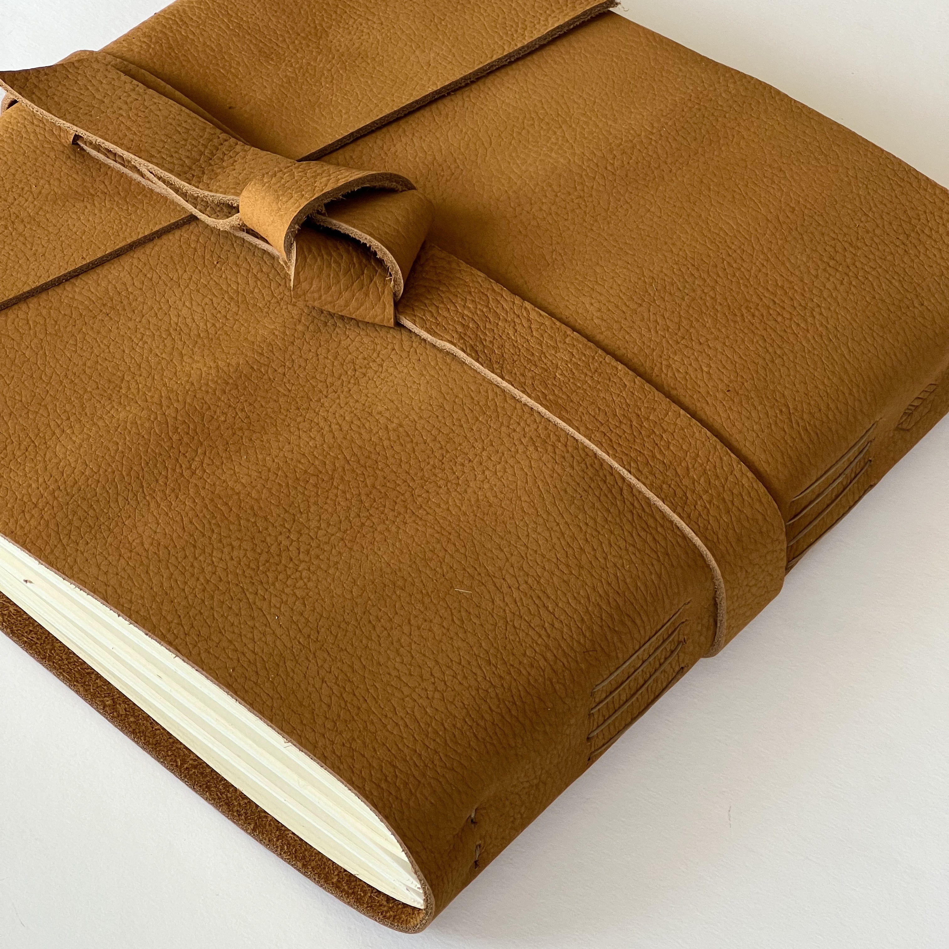 Handmade honey leather photo album or wedding guest book featuring genuine leather