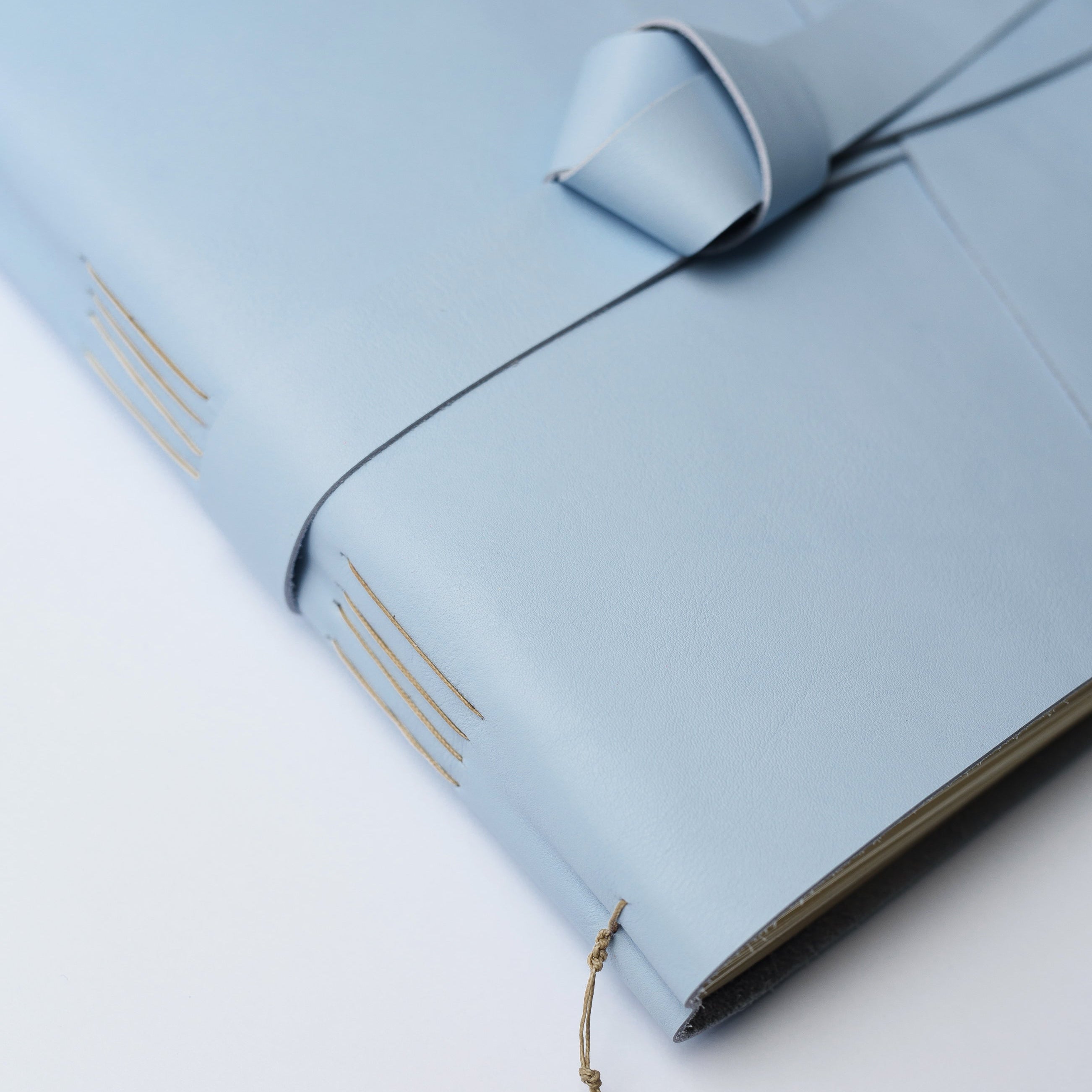 A light blue leather photo album