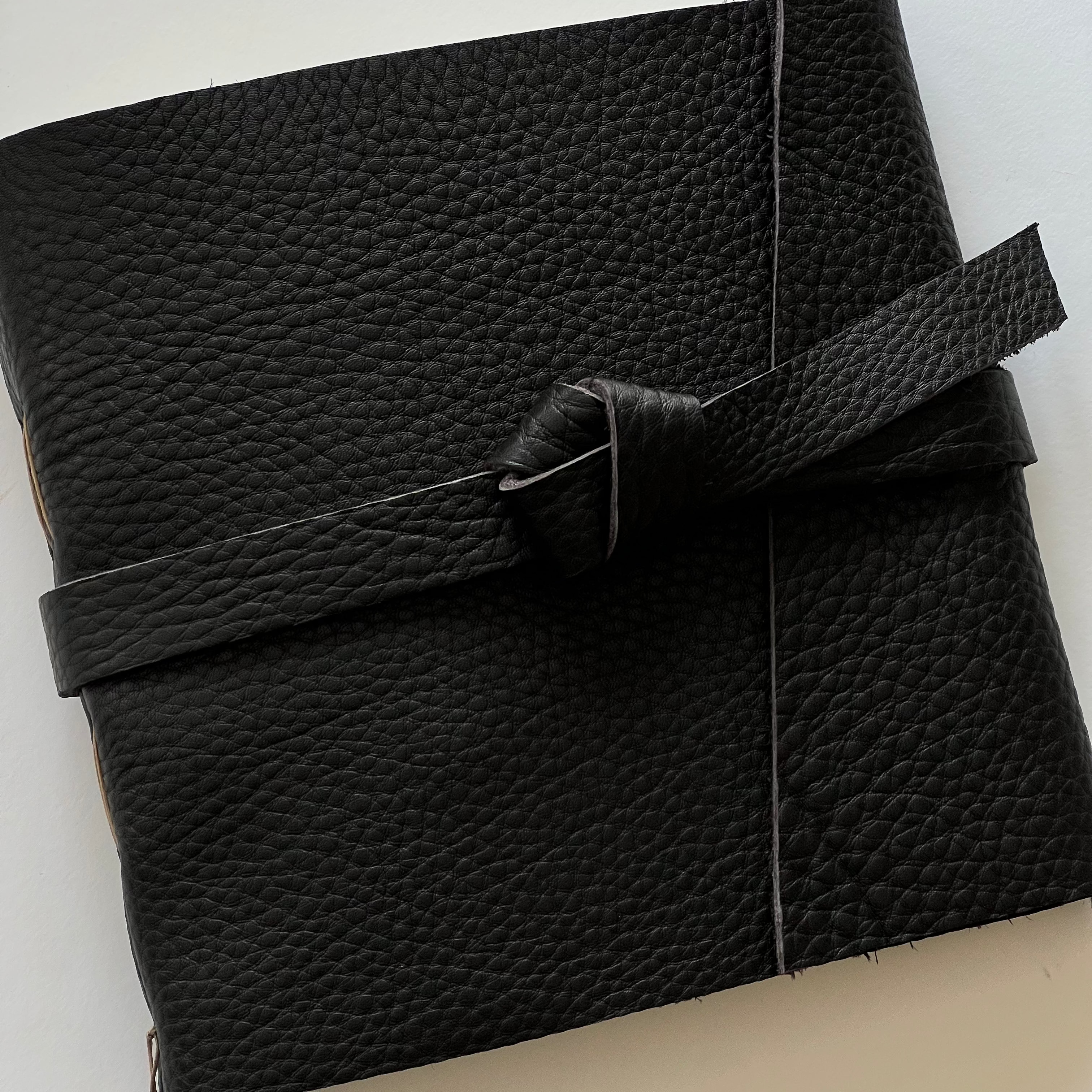 Handmade dark chocolate leather photo album featuring genuine leather and engraving.
